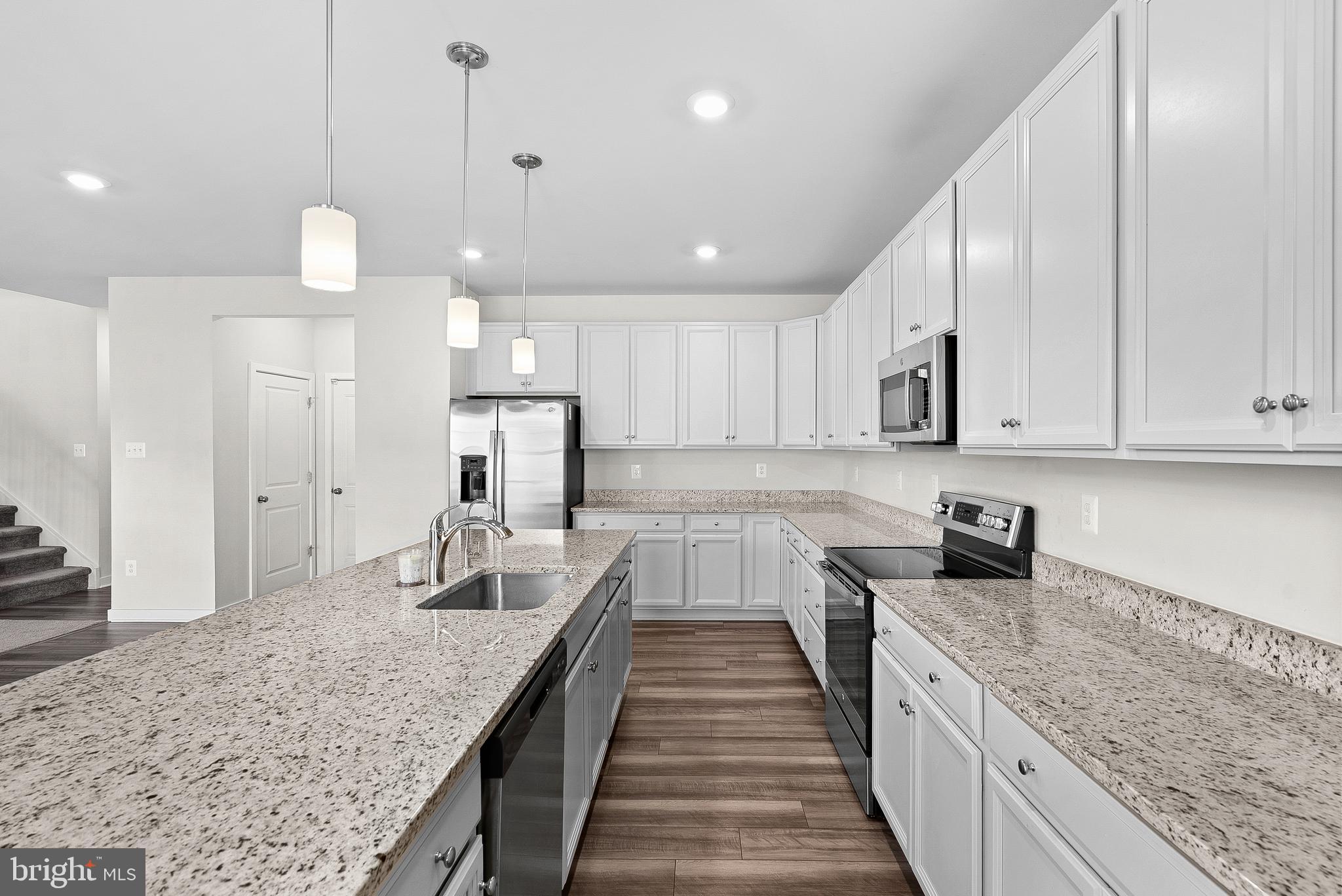 261 Short Br Drive Ranson, WV 25438 - Photo 26 of 71 a large kitchen with kitchen island granite countertop a large counter space a sink stainless steel appliances and cabinets