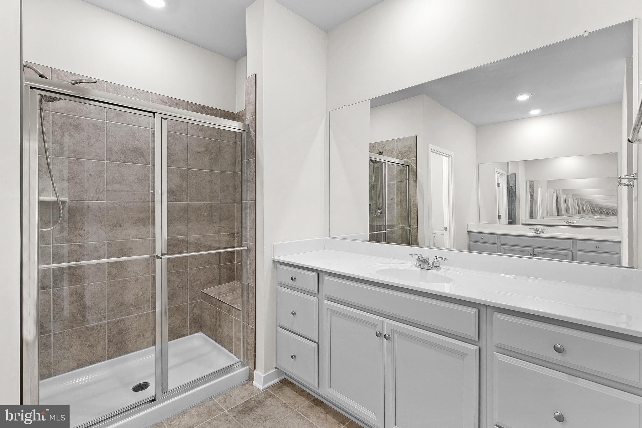 261 Short Br Drive Ranson, WV 25438 - Photo 34 of 71 a bathroom with a shower sink and mirror