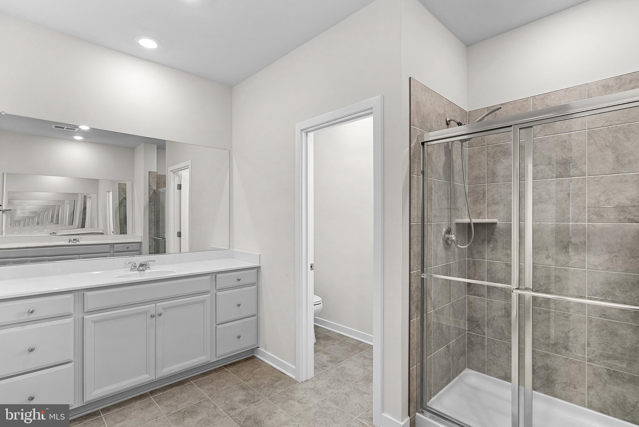 261 Short Br Drive Ranson, WV 25438 - Photo 38 of 71 a spacious bathroom with a shower sink and mirror