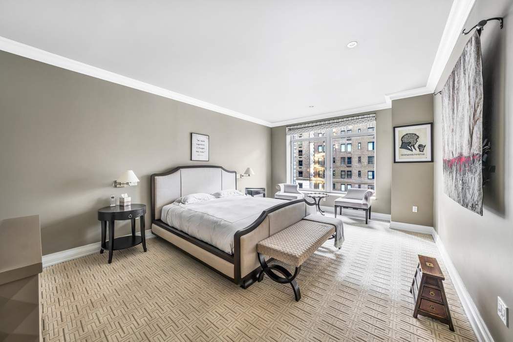 515 Park Avenue, Unit 5A Manhattan, NY 10022 - Photo 11 of 19 a spacious bedroom with a bed a table and a bookshelf