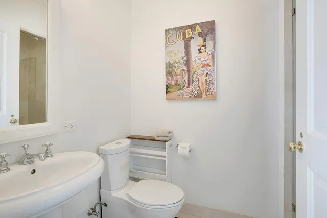 a white toilet sitting next to a bathroom sink
