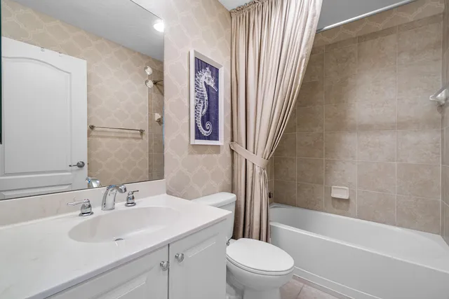 a bathroom with a sink a toilet and a bathtub