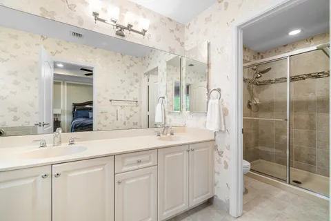 a bathroom with a shower sink and mirror