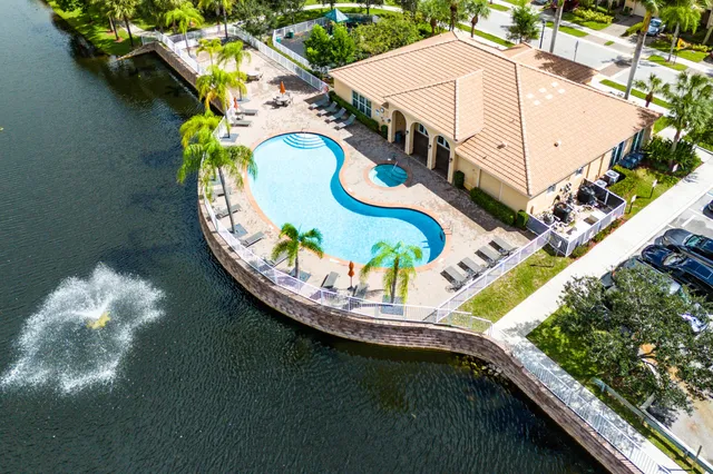 a view of a swimming pool with a yard in back