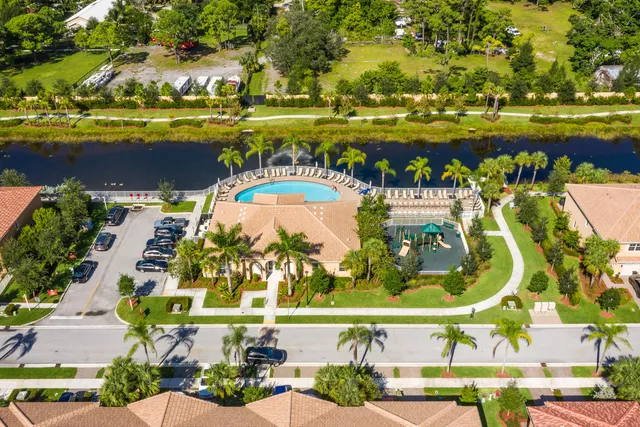 an aerial view of residential houses with outdoor space and swimming pool