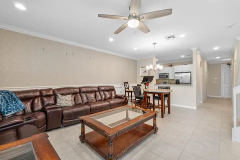 a living room with furniture and kitchen view