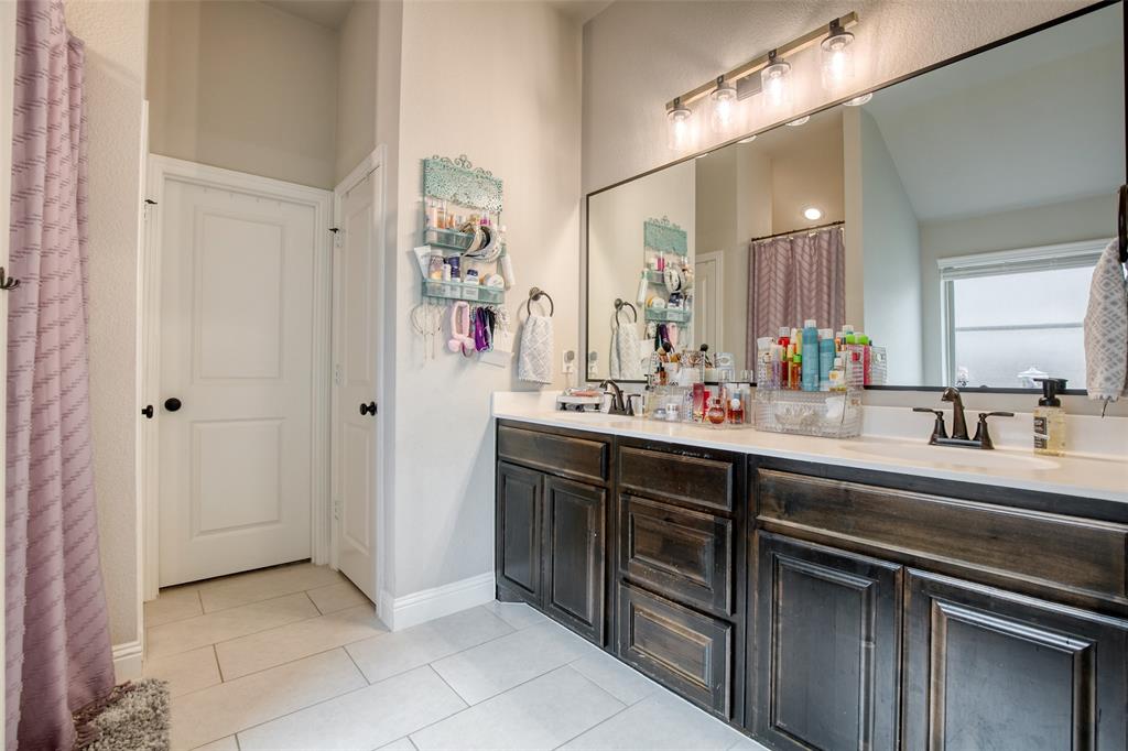 211 Rees Avenue Godley, TX 76044 - Photo 12 of 18 a bathroom with a sink and a mirror
