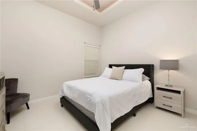 a bedroom with a bed and a night stand