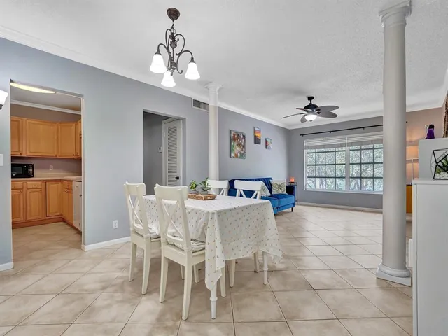 a view of a dining room with furniture and chandelier