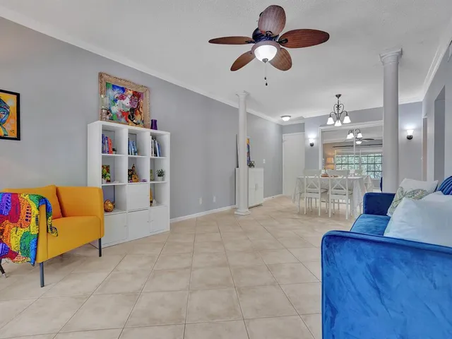 a living room with furniture and kitchen view