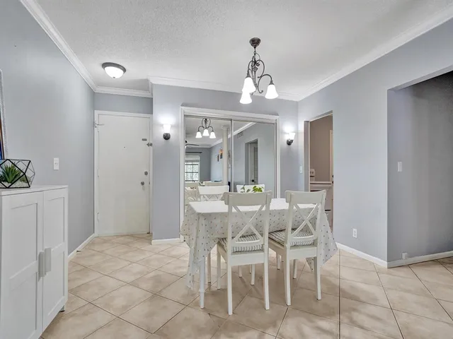a view of a dining room with furniture and chandelier