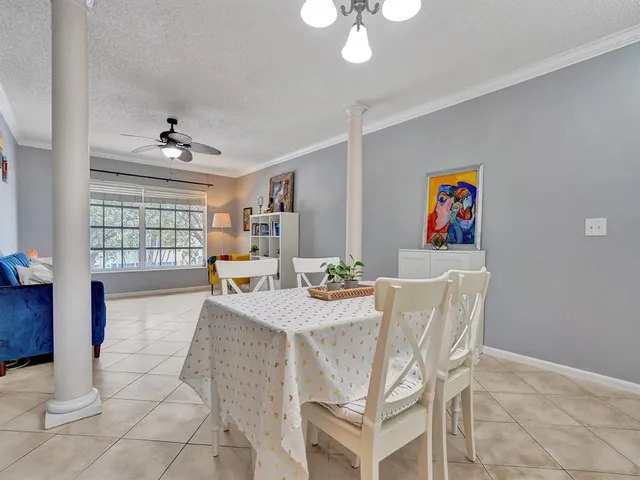 a view of a dining room with furniture and chandelier