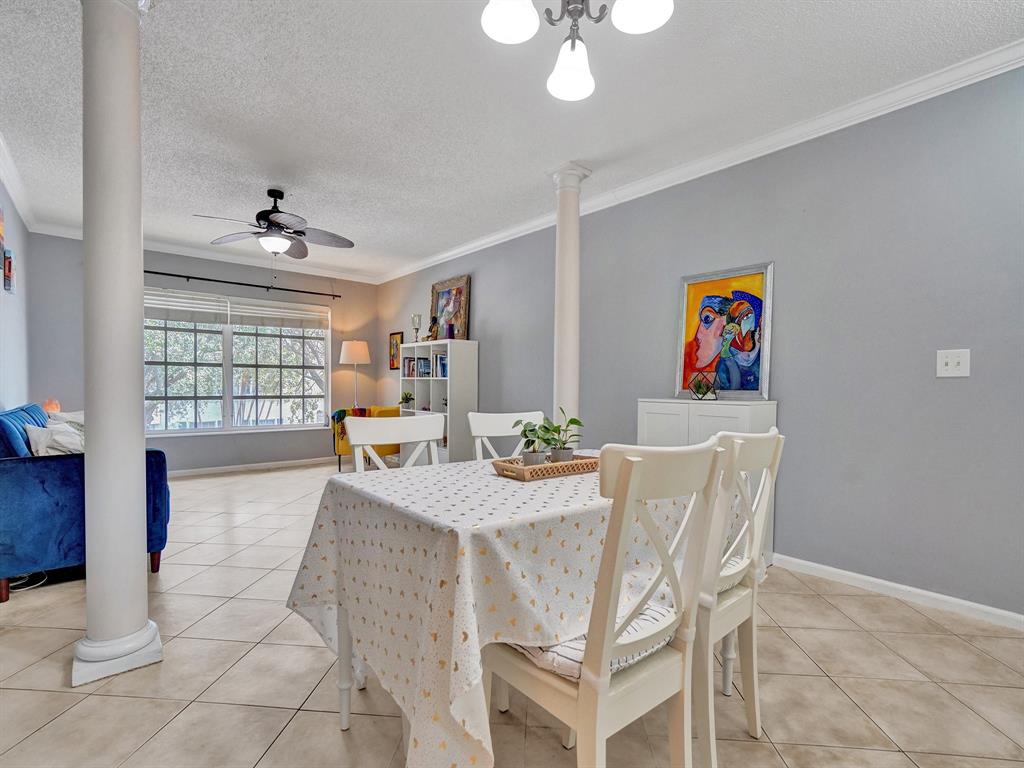 2250 Northeast 66th Street, Unit 1523 Fort Lauderdale, FL 33308 - Photo 21 of 30 a view of a dining room with furniture and chandelier