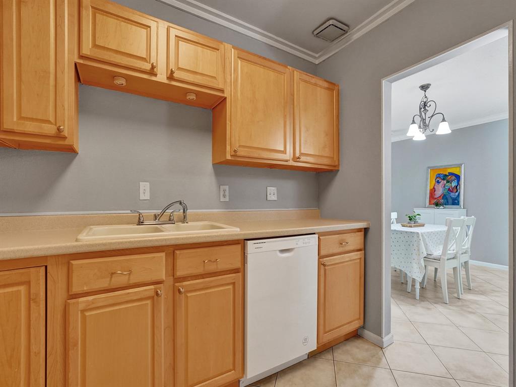 2250 Northeast 66th Street, Unit 1523 Fort Lauderdale, FL 33308 - Photo 25 of 30 a kitchen with stainless steel appliances granite countertop a sink and cabinets