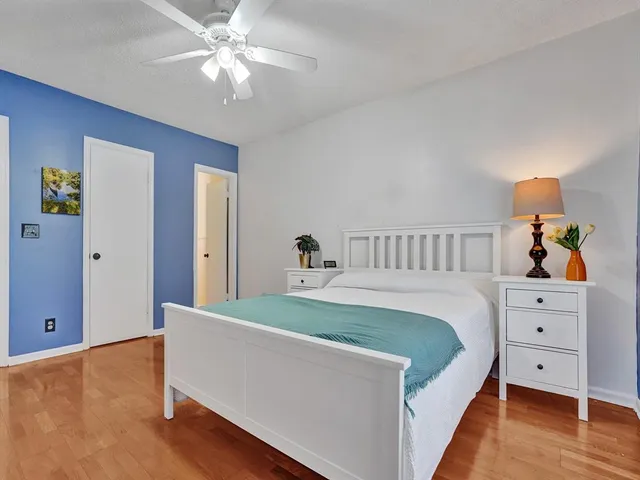 a bed room with a bed and a chandelier