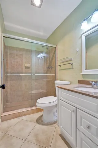 a bathroom with a toilet a sink and shower