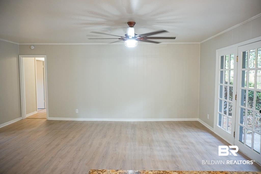 6205 Zeigler Boulevard Mobile, AL 36608 - Photo 4 of 17 Spare room with wood finished floors, ornamental molding, and ceiling fan