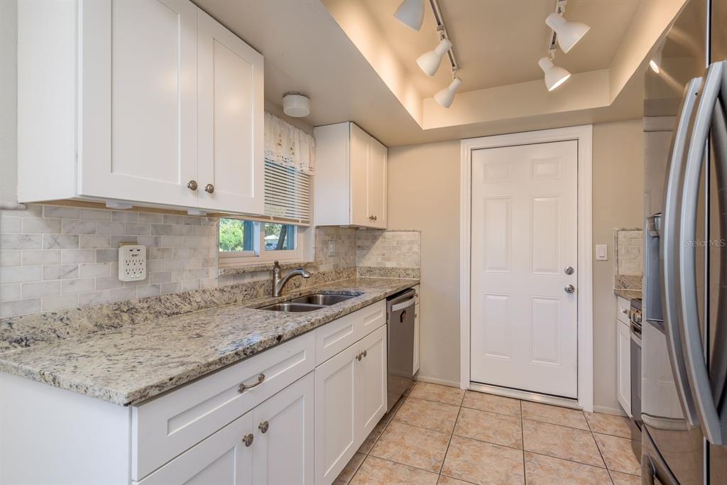 1104 Carlton Road Tarpon Springs, FL 34689 - Photo 12 of 35 a kitchen with a sink and cabinets