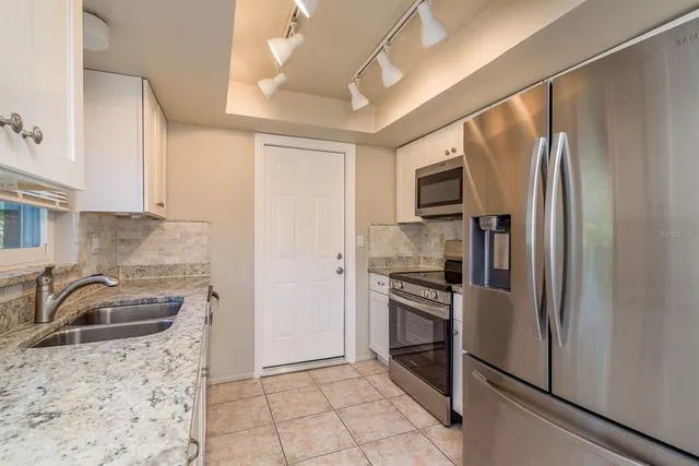 a kitchen with a refrigerator sink and microwave