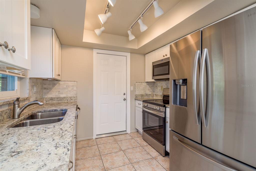 1104 Carlton Road Tarpon Springs, FL 34689 - Photo 13 of 35 a kitchen with a refrigerator sink and microwave