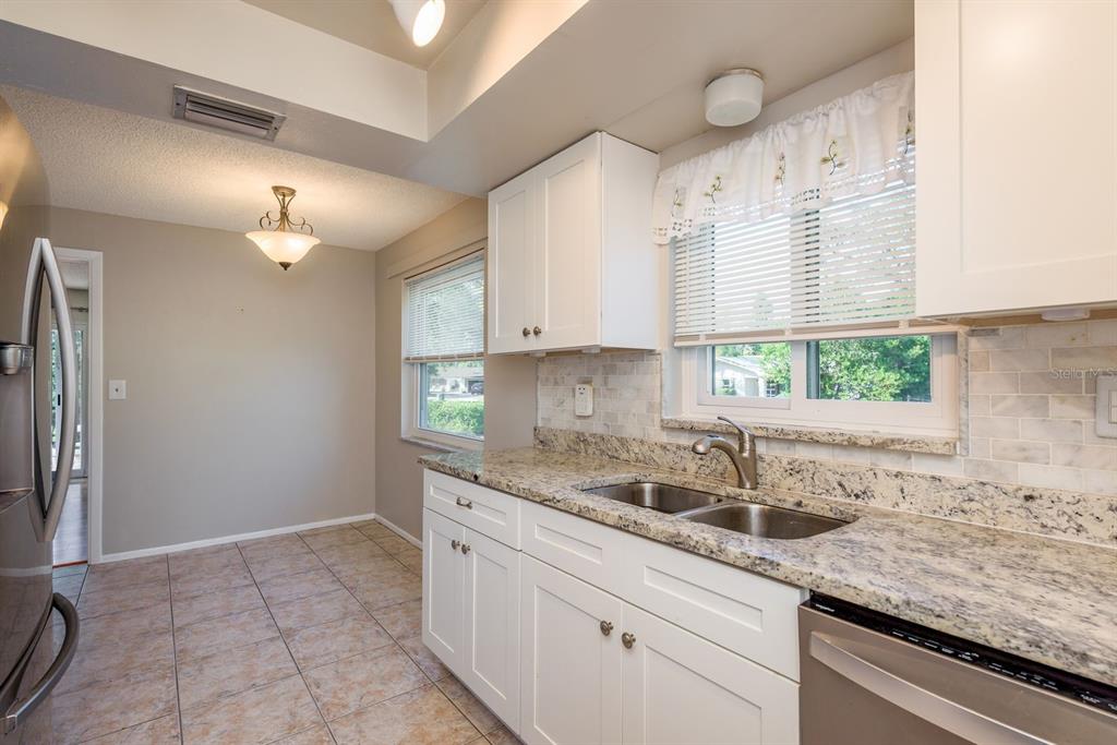 1104 Carlton Road Tarpon Springs, FL 34689 - Photo 15 of 35 a kitchen with a sink cabinets and window