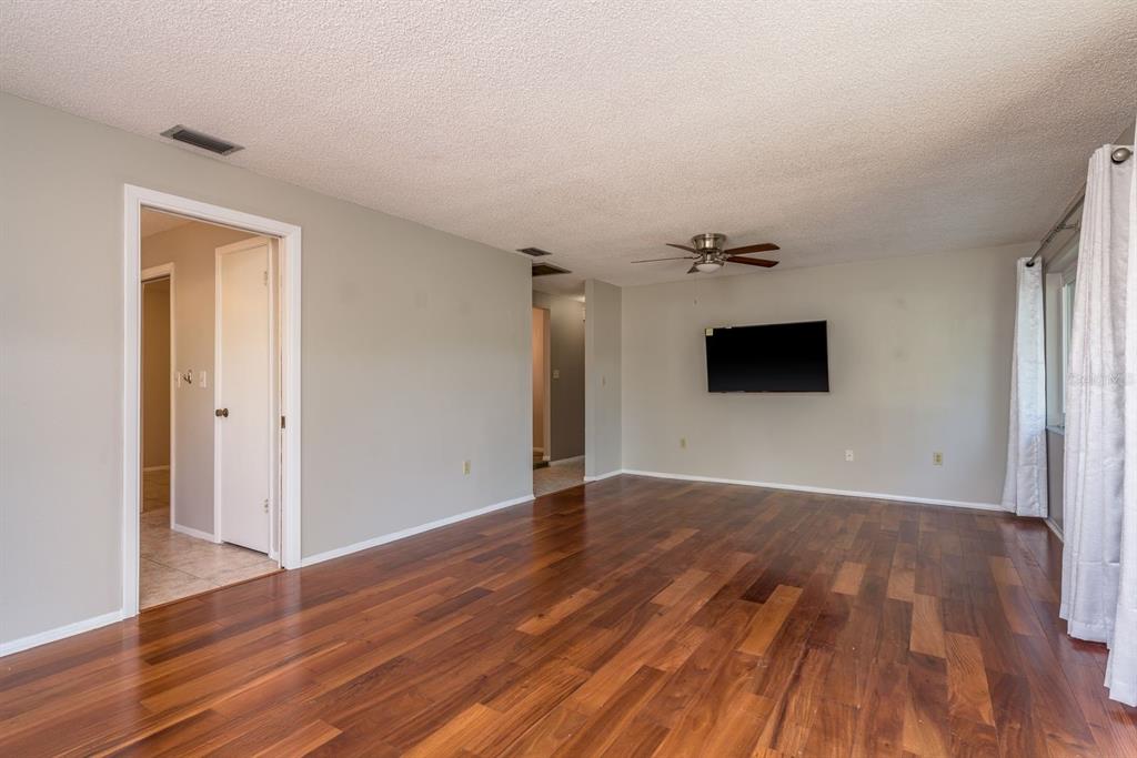 1104 Carlton Road Tarpon Springs, FL 34689 - Photo 18 of 35 a view of empty room with wooden floor