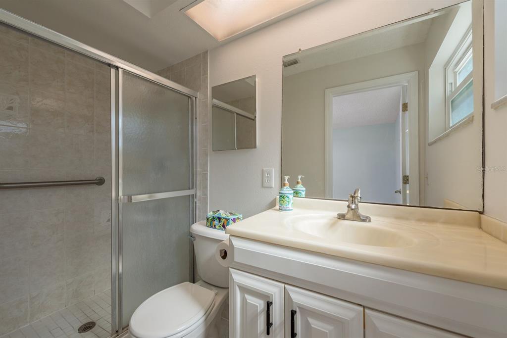 1104 Carlton Road Tarpon Springs, FL 34689 - Photo 22 of 35 a bathroom with a sink toilet and shower