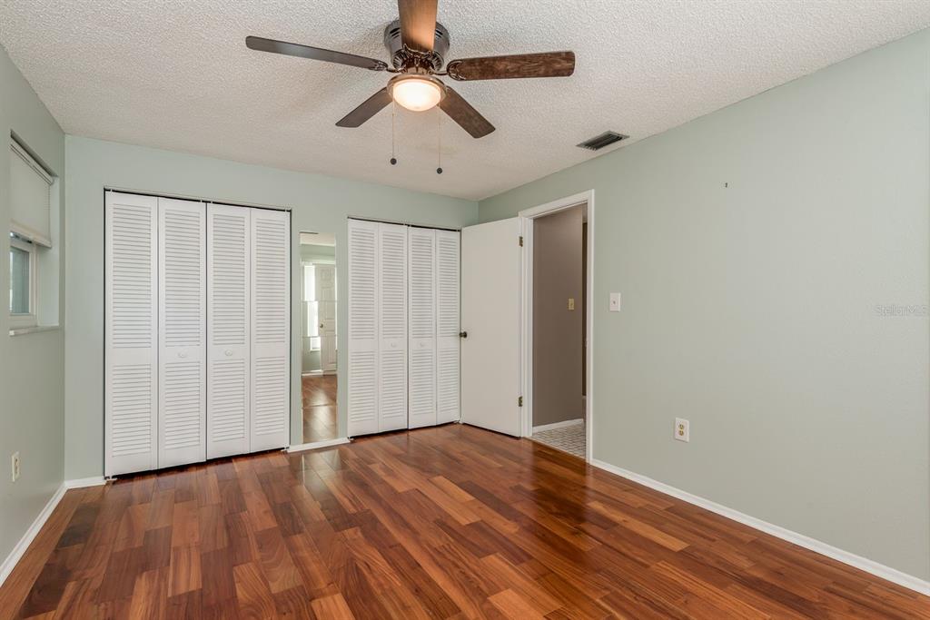 1104 Carlton Road Tarpon Springs, FL 34689 - Photo 24 of 35 a view of an empty room with wooden floor