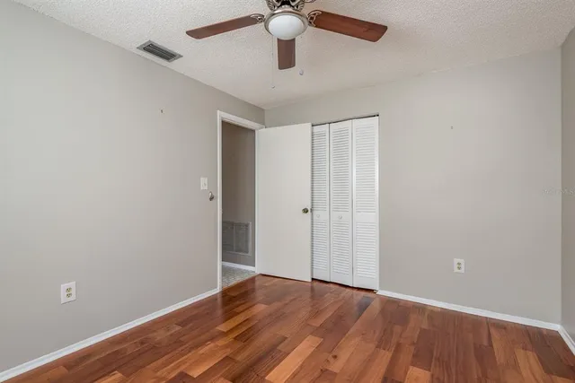 a view of an empty room and wooden floor