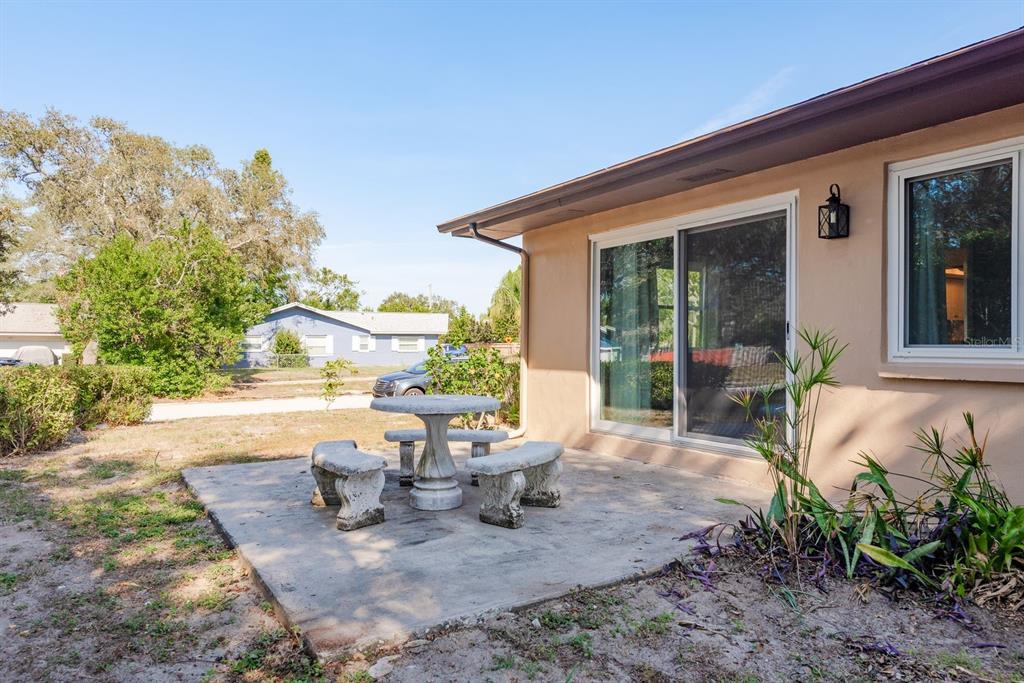 1104 Carlton Road Tarpon Springs, FL 34689 - Photo 35 of 35 a view of a patio with table and chairs and potted plants