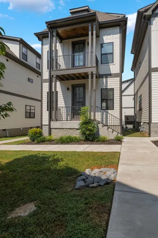 a front view of a house with swimming pool having outdoor seating