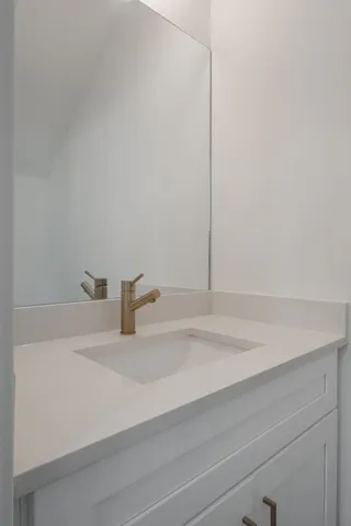 a bathroom with a sink and vanity
