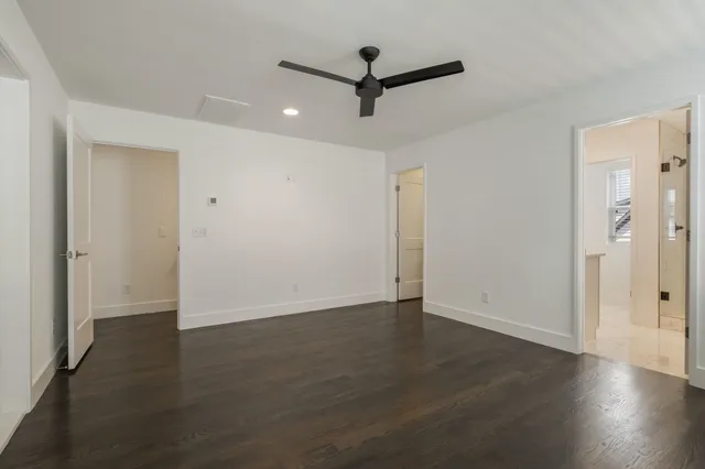 a view of a livingroom with wooden floor and a ceiling fan