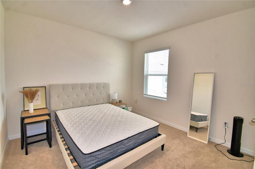 2839 Moulin Road Davenport, FL 33837 - Photo 52 of 75 a bedroom with a bed and a desk