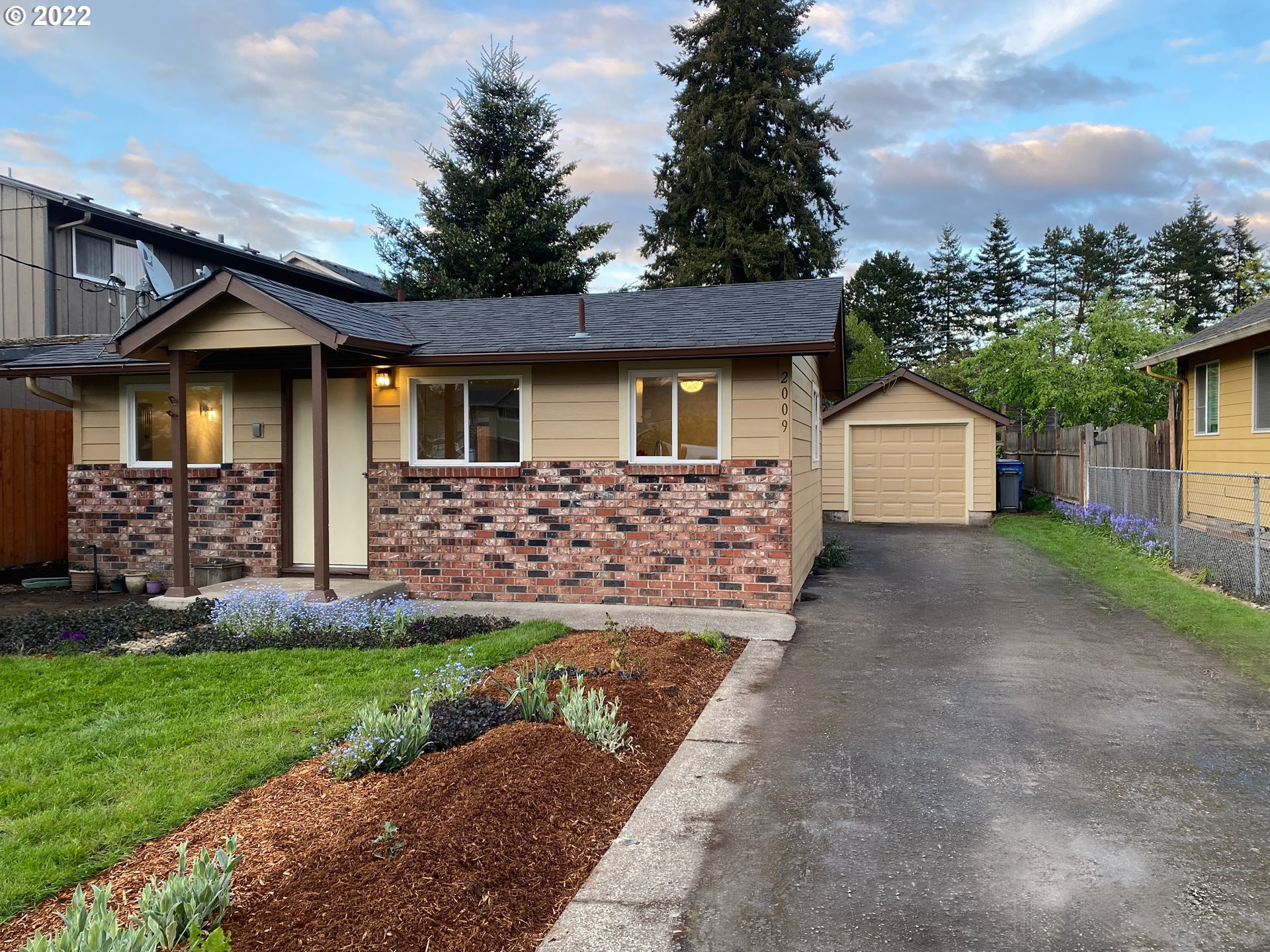 2009 Carlson Road Vancouver, WA 98661 - Photo 2 of 28 a front view of a house with a yard and garage