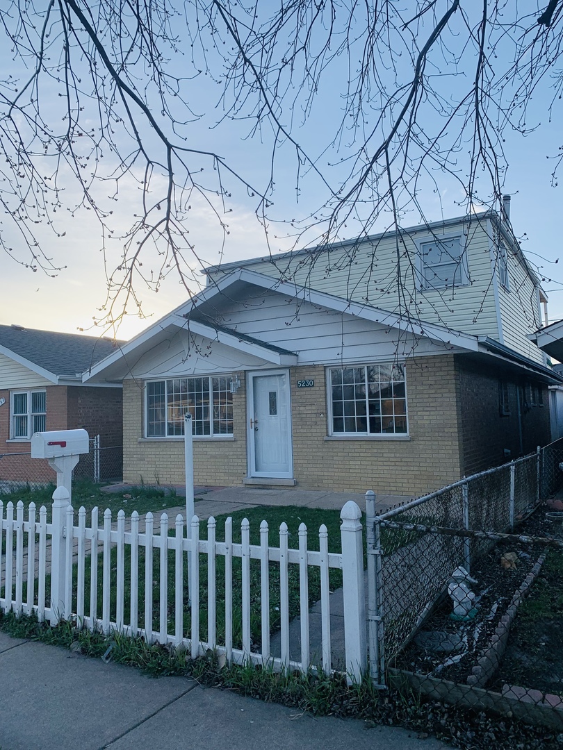 5230 State Road Burbank, IL 60459 - Photo 1 of 26 a front view of a house with a garden