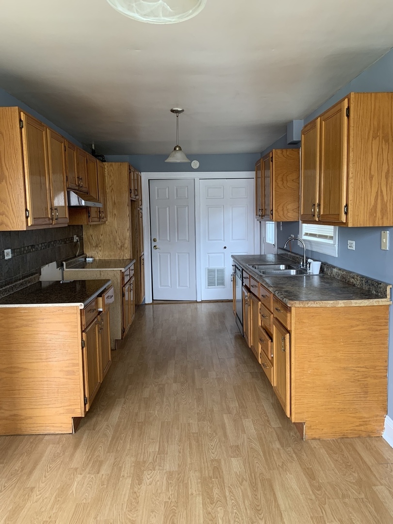 5230 State Road Burbank, IL 60459 - Photo 25 of 26 a kitchen with stainless steel appliances granite countertop a stove a sink and a refrigerator