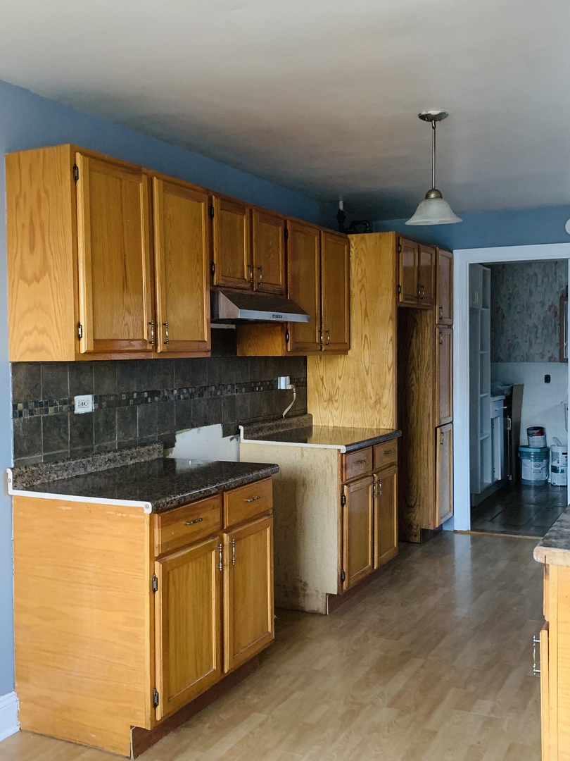 5230 State Road Burbank, IL 60459 - Photo 6 of 26 a kitchen with a refrigerator and a sink