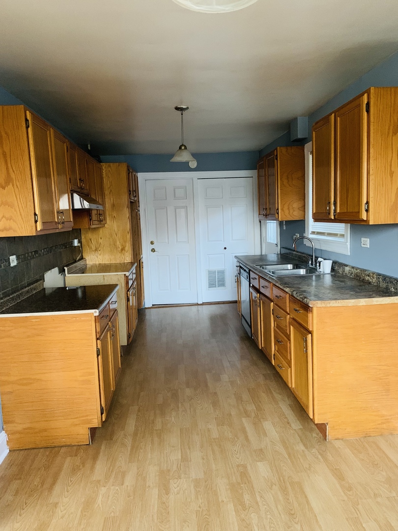 5230 State Road Burbank, IL 60459 - Photo 7 of 26 a kitchen with stainless steel appliances granite countertop a sink stove and refrigerator