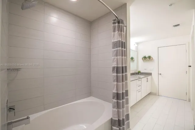 a bathroom with a bathtub and a shower