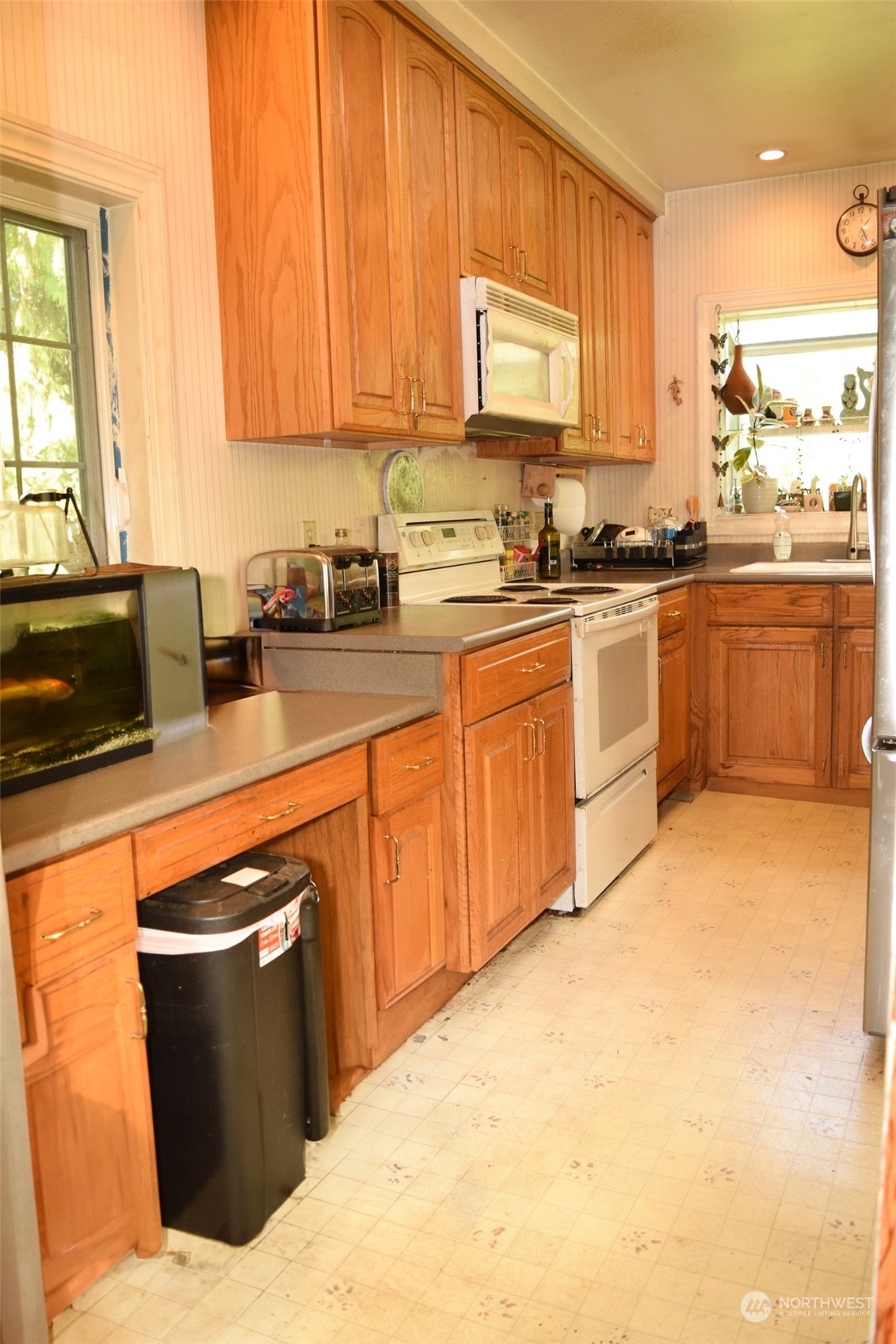 12238 Military Road South Seattle, WA 98168 - Photo 5 of 16 a kitchen with stainless steel appliances granite countertop a stove a sink and a microwave