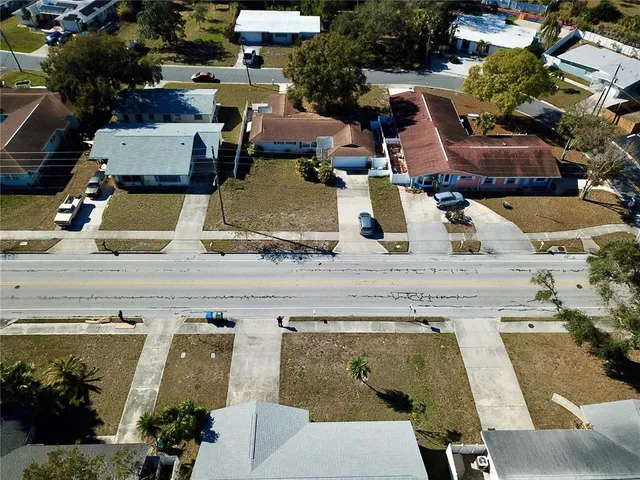 an aerial view of a house with garden space and street view