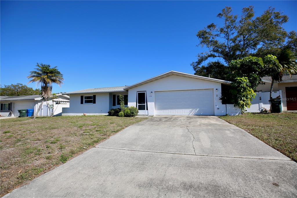 120 20th Street Southwest Largo, FL 33770 - Photo 22 of 46 a front view of a house with a yard and garage