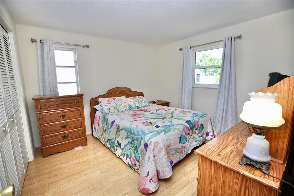120 20th Street Southwest Largo, FL 33770 - Photo 23 of 46 a bedroom with a bed and dresser with mirror