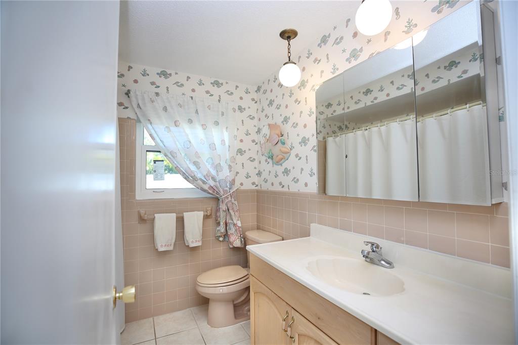 120 20th Street Southwest Largo, FL 33770 - Photo 29 of 46 a bathroom with a sink a toilet and a mirror