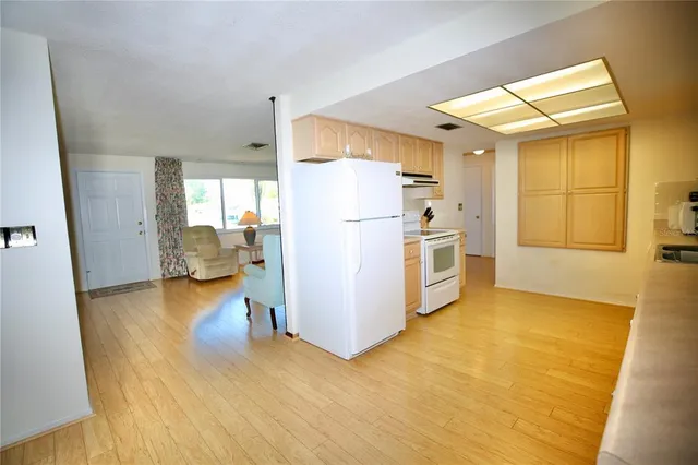 a kitchen with a refrigerator a stove and a sink