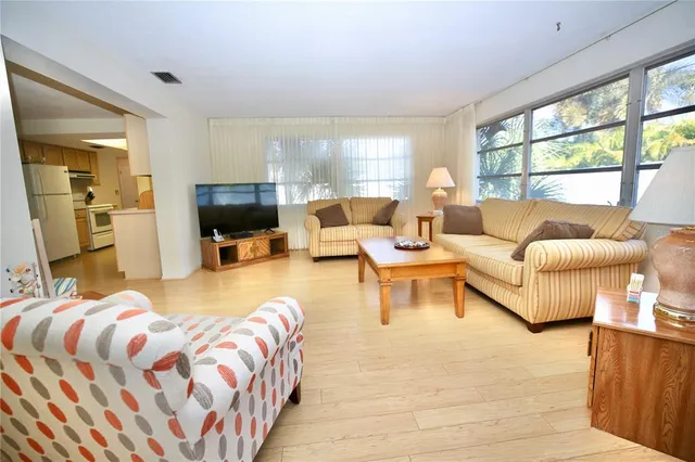 a bedroom with a bed and large window