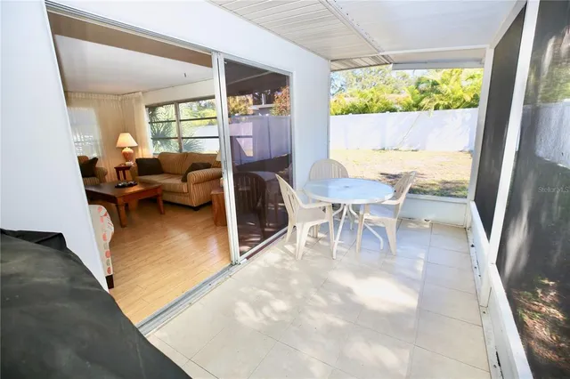 a living room with couches a coffee table and a large window with garden view