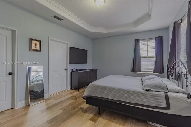 a bedroom with a bed and a flat screen tv