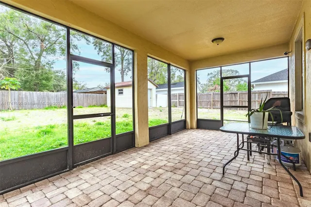 a bedroom with furniture and large windows